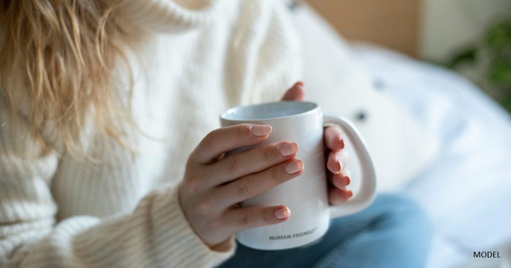 Woman in a warm sweater considering breast lift surgery